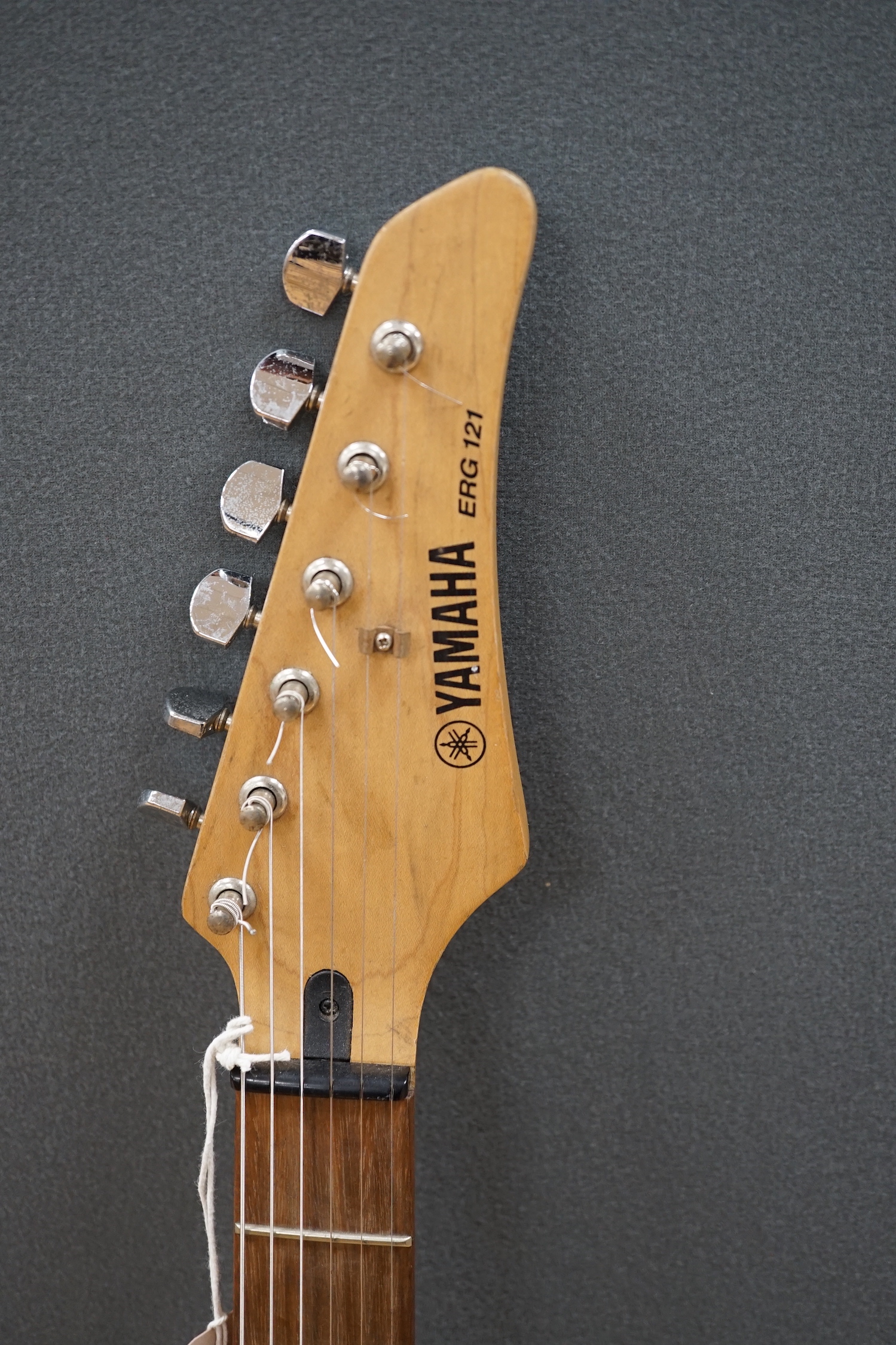 A Yamaha electric guitar, ERG 121, with black lacquer body and a small Carlsbro Kickstart practice amp